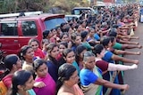 Rows of women of all ages creating a human wall.