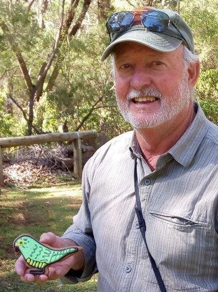 Man in cap holding a bird-shaped biscuit