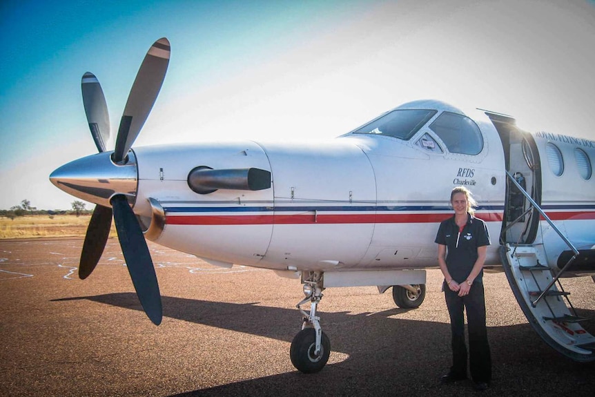 Lady standing outside an RFDS plane.