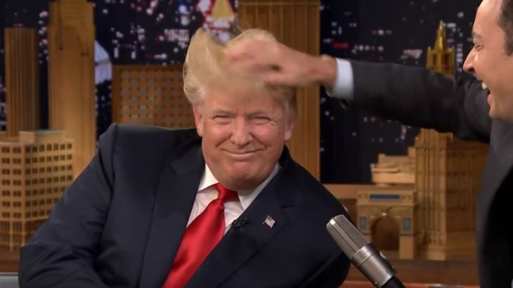 Donald Trump smiles as Jimmy Fallon messes with his hair