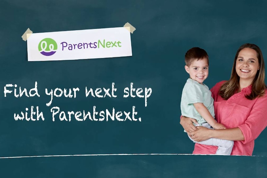 A woman holds a young child near a sign for ParentsNext, it says 'find your next step with Parents Next'