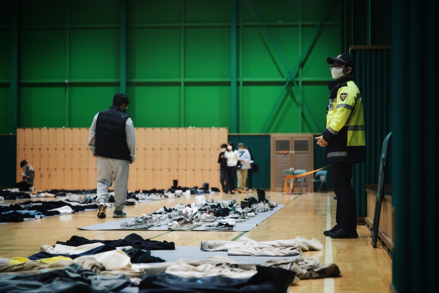 Observers at a lost-and-found centre where the belongings left during Seoul's Halloween crush are displayed. 