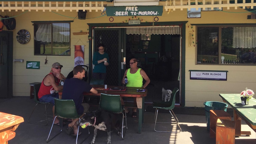 Australian men seated around a table under Warrell Creek Tavern sign.