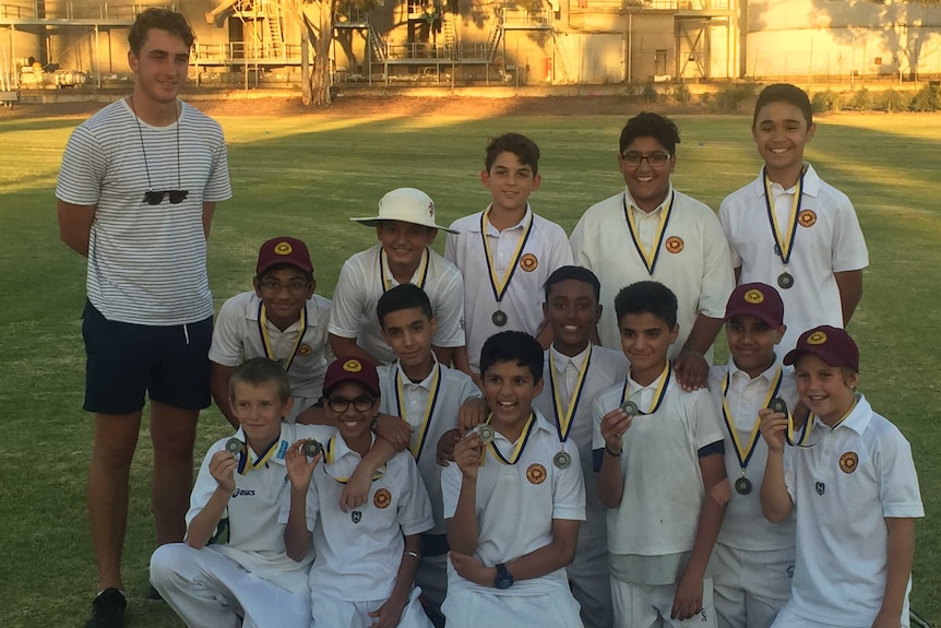 Peter Hatzoglou with the victorious U/13 junior cricket team at Sunshine Heights Cricket Club.