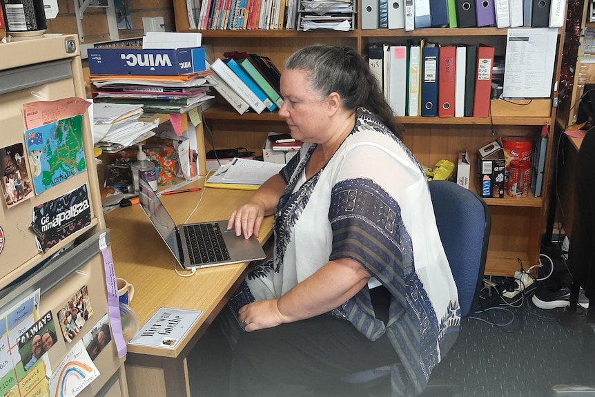  Gemma McWhirter sitting at her desk working on her laptop. 