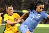 Australia's Hayley Raso tussles with France's Sakina Karchaoui during a football game.