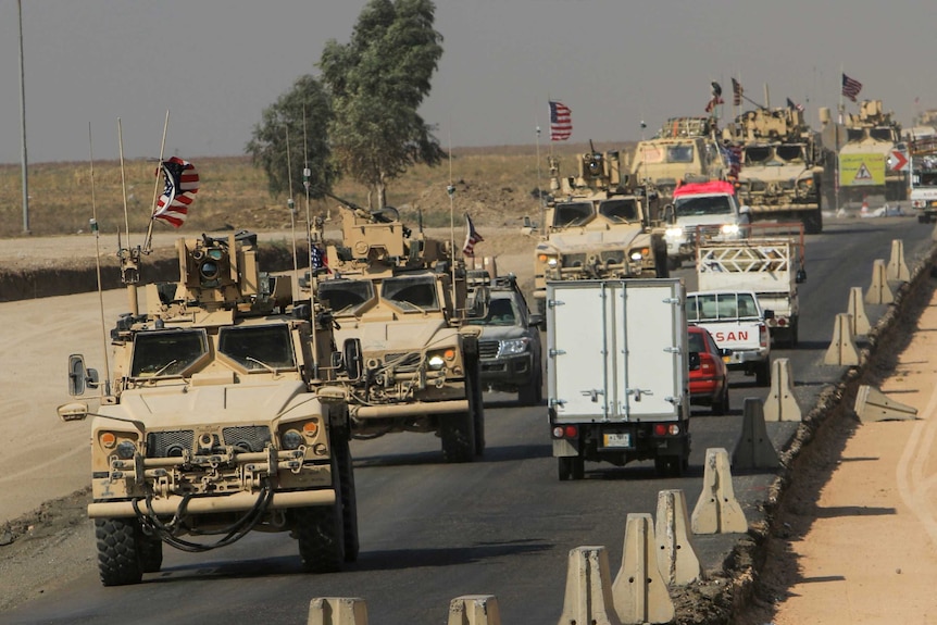 A United States military convoy moves through Syria.