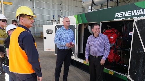 people stand in front of engine