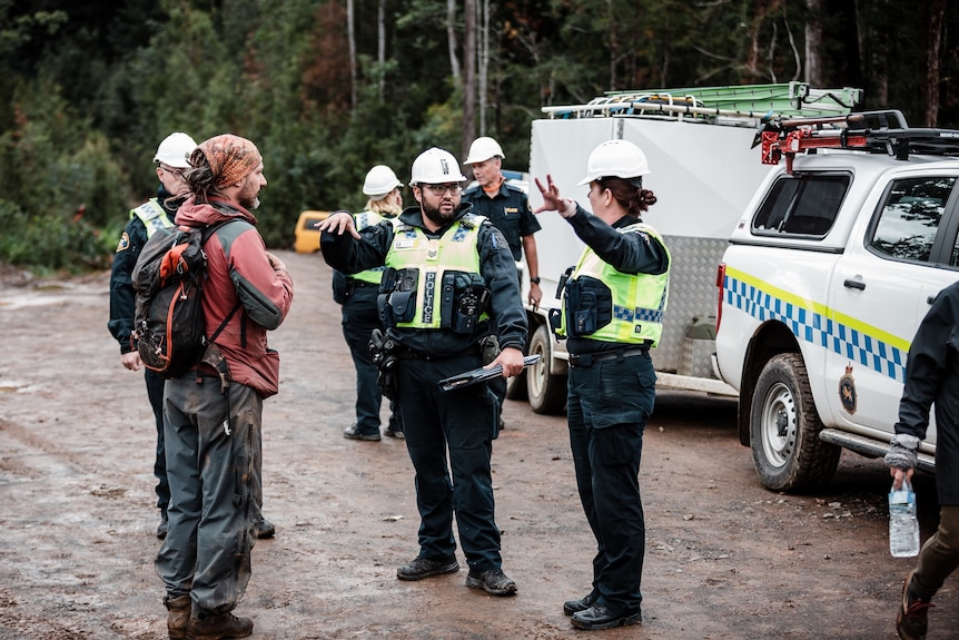 Polizei und Anti-Logging-Demonstranten in einer Gruppe.