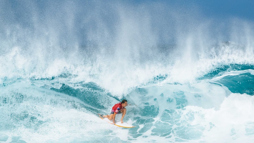 Australian surfer Julian Wilson rides a wave