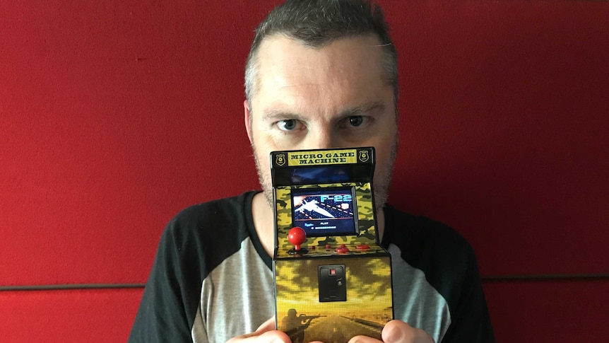 Andrew Hogan with his tiny electronic game.