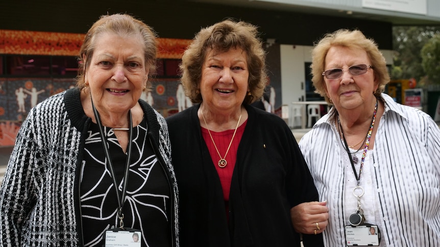 Three elderly women smiling