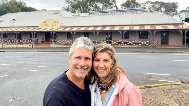 male and female take a selfie infront of a regional pub