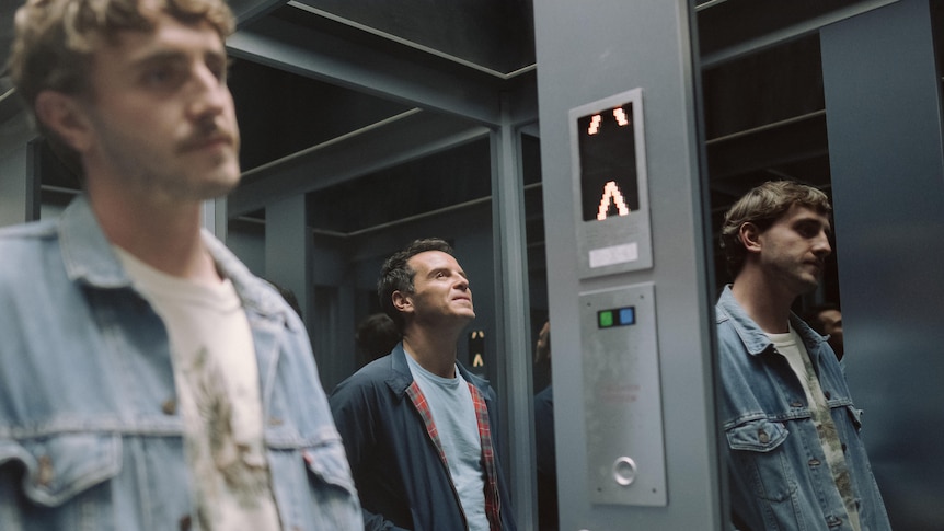 A film still of Paul Mescal and Andrew Scott standing in an elevator. Mescal is slightly out of focus and in the front of frame.