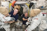 Astronauts Kate Rubins and Jeff Williams prepare their spaces suits.