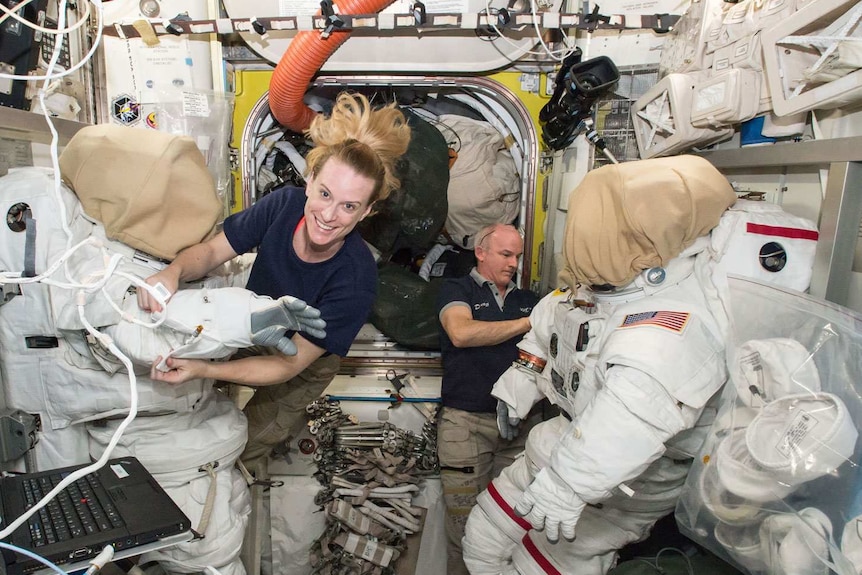 Astronauts Kate Rubins and Jeff Williams prepare their spaces suits.