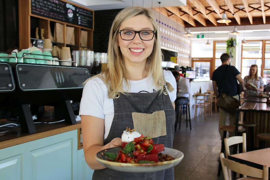 Caity Reynolds in The Cupping Room with a plate of food.