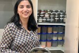 Simran Singh standing in front of her pantry at home