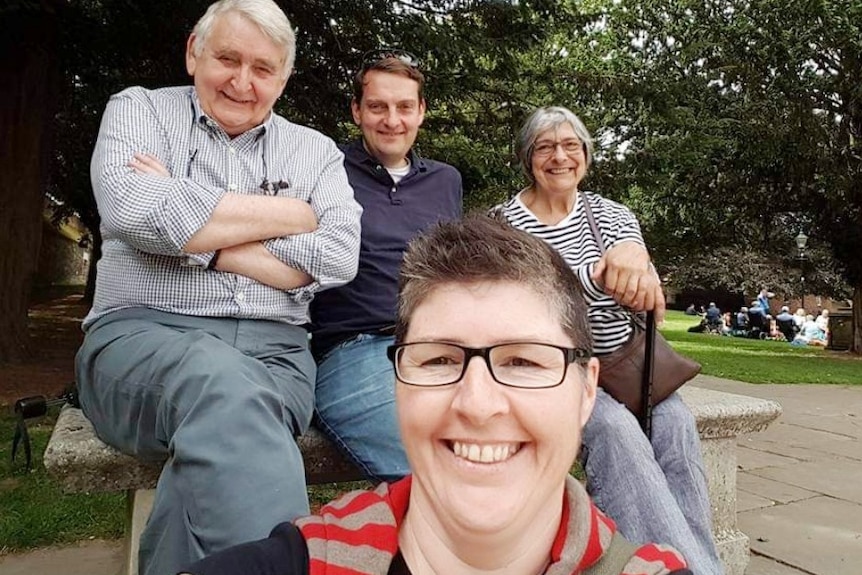 Two women and two men sit in a park.