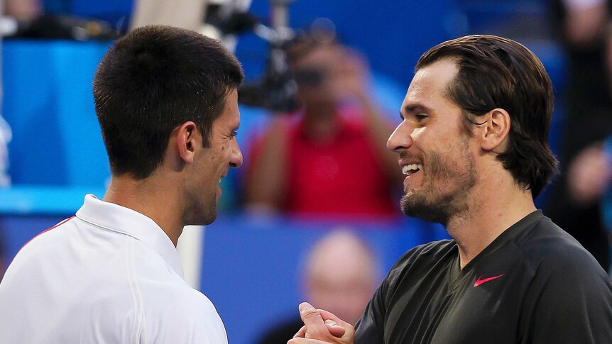 Serbia's Novak Djokovic (L) shakes hands with Tommy Haas of Germany (R) at the Hopman Cup.
