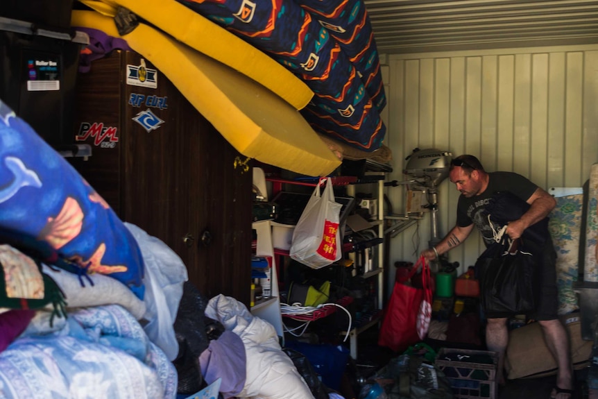 Brian Willcox gathers supplies from a sea container