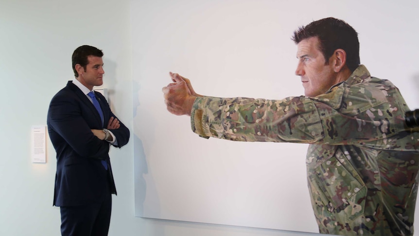 VC winner Ben Roberts Smith with large portrait at the Australian War Memorial.