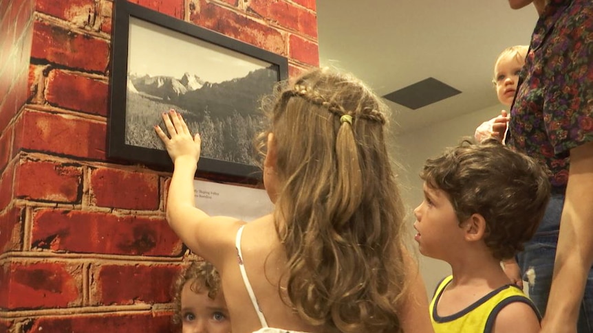 Children touching a photo