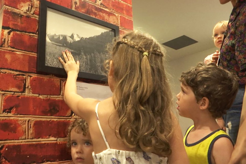 Children touching a photo