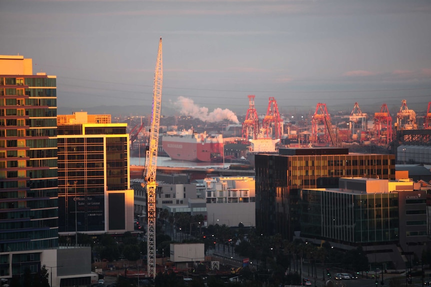 A view of the port of Melbourne with a crane in the foreground