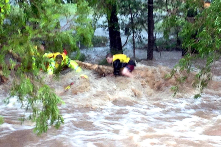 An SES volunteer rescues a stranded teenager in Rockhampton.