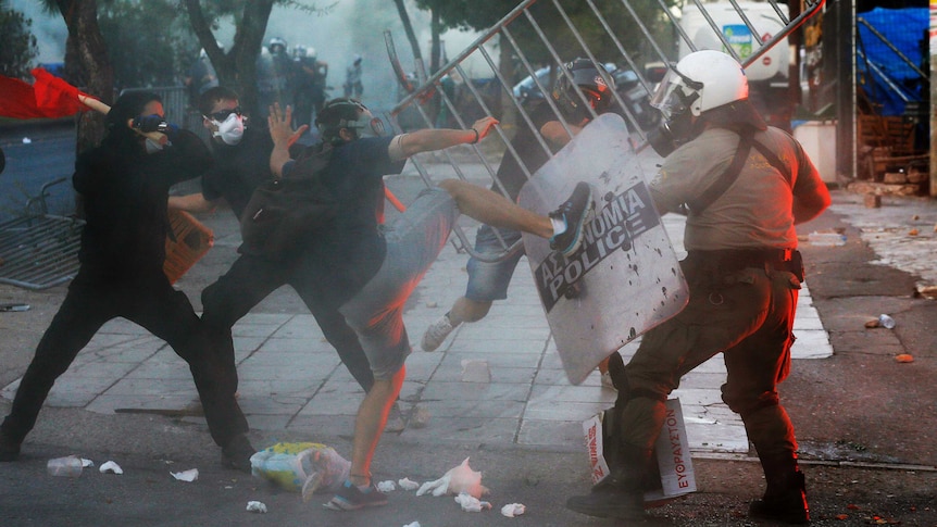 Riot police clash with anti-fascist protesters in Athens