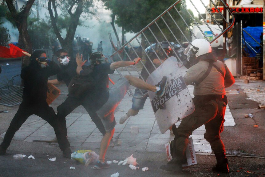 Riot police clash with anti-fascist protesters in Athens