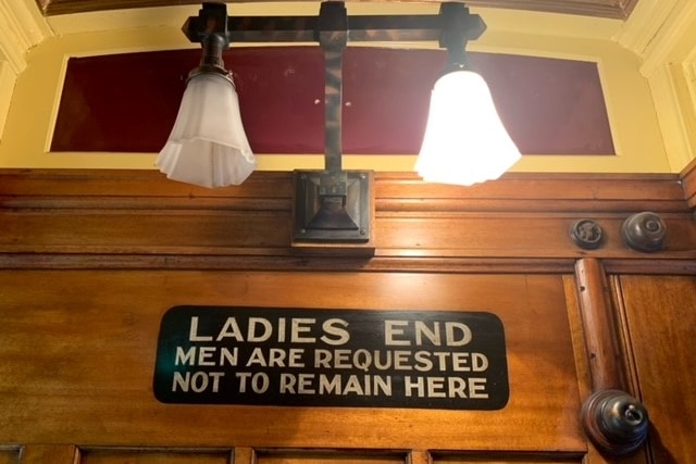 a sign reads "Ladies End. Men are requested not to remain here"