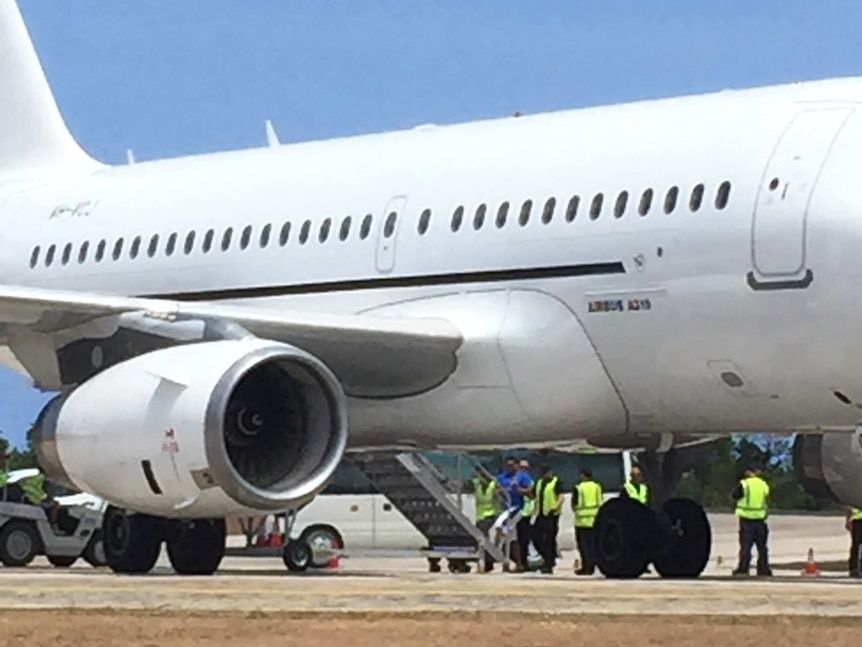 Detainees getting onto plane