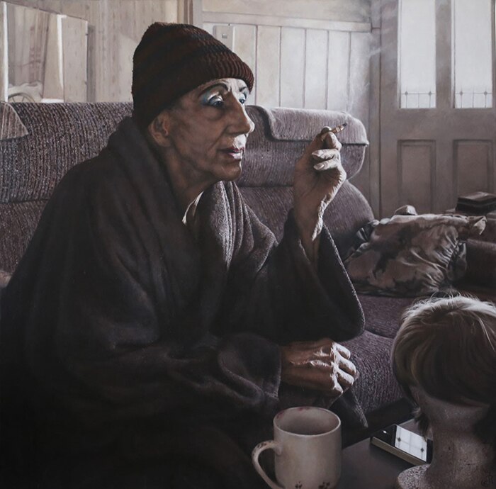 A portrait of a man sitting in his lounge room smoking and wearing a beanie. The work is titled Just an Old Drag Queen.