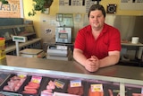 Mark Woolfe leaning on his butcher's counter