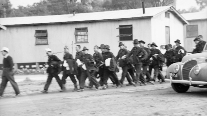 Japanese prisoners of war marching in camp.