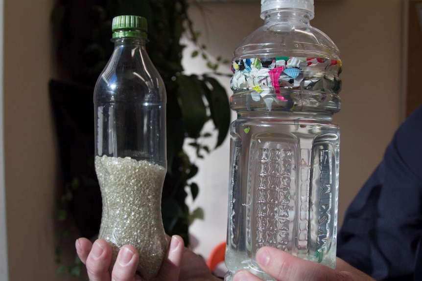 Two bottles containing recycled plastic beads and floating plastic bits