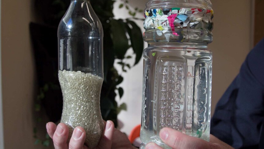 Two bottles containing recycled plastic beads and floating plastic bits