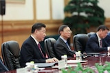 A close up photo of Xi Jinping speaking around a table at the forum.