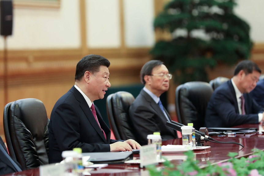 A close up photo of Xi Jinping speaking around a table at the forum.