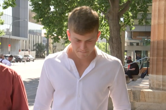 A man in a white shirt leaving court.