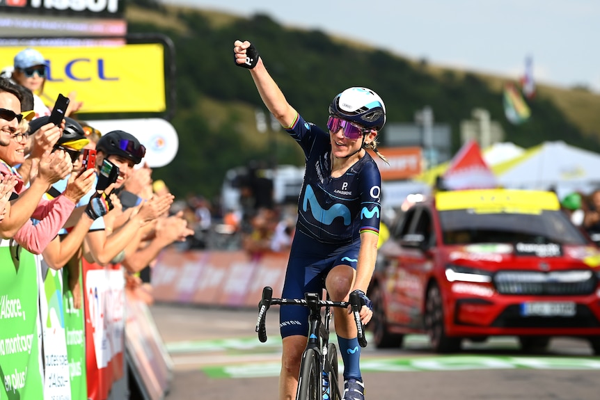 A Dutch cyclist smiles and clenches her fist in celebration after winning a stage in the Tour de France Femmes.