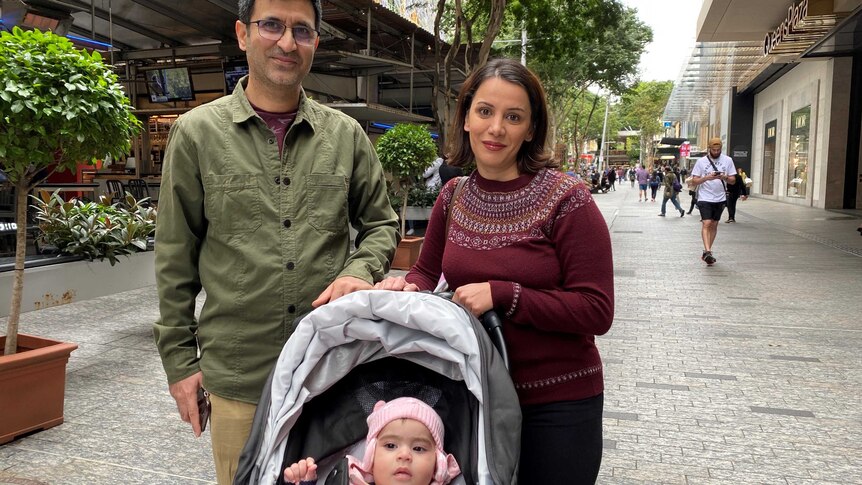 Mohammad and Marcia Javadi from the Gold Coast all rugged up with their child.