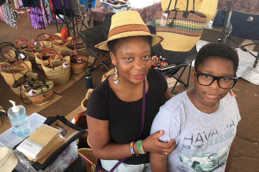 a woman with her son at a market stall