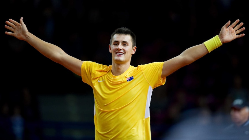 Australia's Bernard Tomic celebrates victory over Poland's Lukasz Kubot in the Davis Cup.