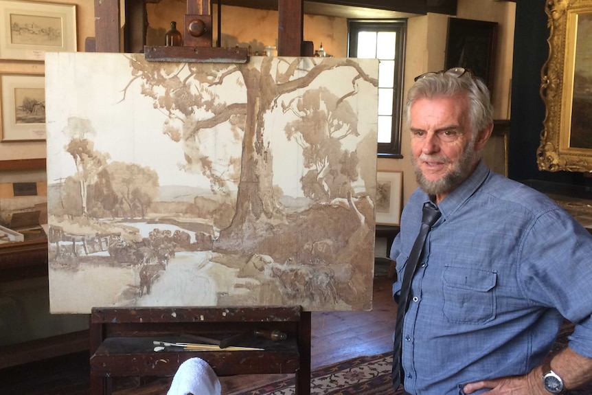 Allan Campbell with an unfinished Sir Hans Heysen painting.