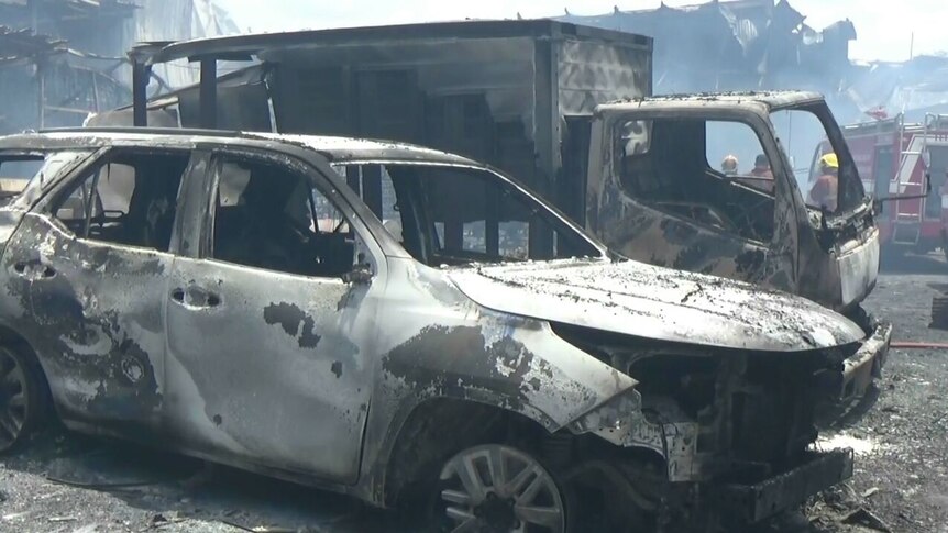 A burnt out car and truck.