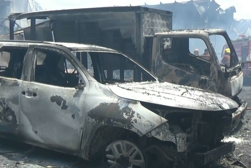 A burnt out car and truck.