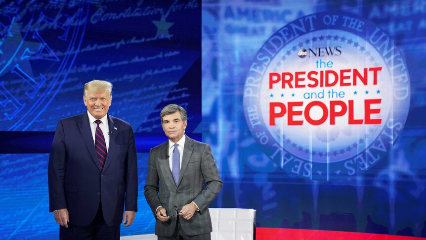 US President Donald Trump takes the stage with ABC News chief anchor George Stephanopoulos